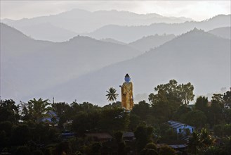 Big Buddha statue against the mountains in the Golden Triangle