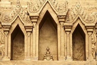 Small Buddha statue in a niche of the Wat Jong Kham