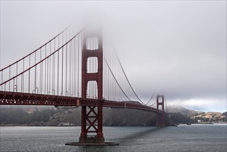 Golden Gate Bridge partially covered in fog