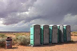 Toilets cubicles in steppe landscape