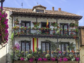 Flower covered balcony on the main square of Santillana del Mar