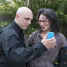 Zombie and man with smartphone