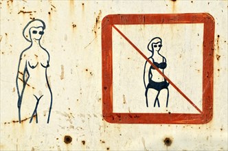 Old sign on a nude beach