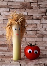 Leek and tomato with faces