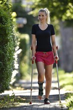 Young woman with crutches