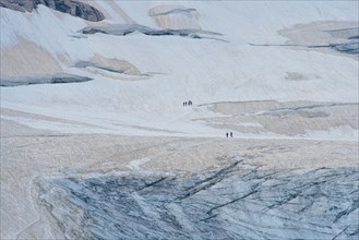People walking on glacier ice