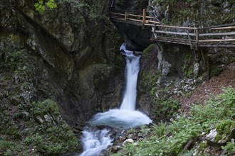 Wooden footbridge over waterfall in the Dr. Vogelgesang gorge at Trattenbach