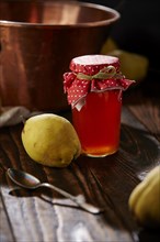 Quince jelly and fruit on wooden table