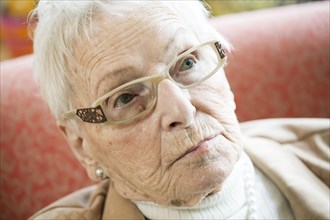 Senior suffering from dementia in a retirement home looking skeptical