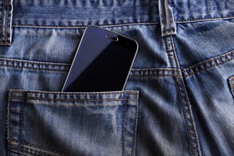 Smartphone in the pocket of jeans