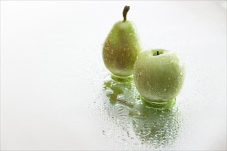 Pear and apple with water drops
