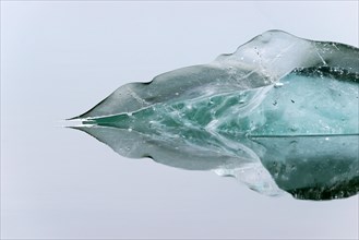 Block of ice floating in water