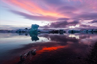 Blue iceberg in sunset