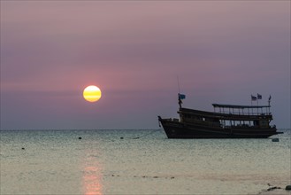 Diving boat in sea at sunset