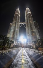 Fountain in front of illuminated Petronas Twin Towers at night