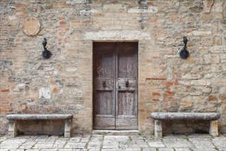 Wooden door and stone benches