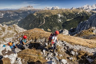 Mountaineer climbing the Cima Valacia on Via Ferrata cable
