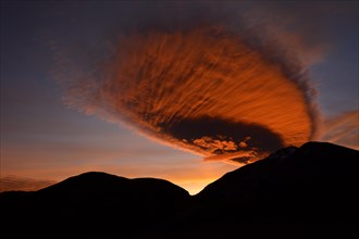 Fiery red clouds above mountain range