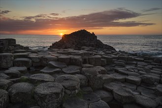 Basalt columns by the coast at sunset