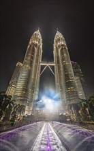 Fountain in front of the illuminated Petronas Tower at night