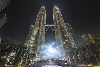 Fountain in front of the illuminated Petronas Tower at night