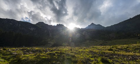 Sun shining over the mountain peak