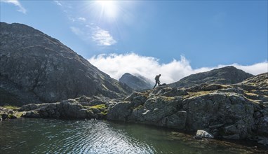 Hiker by a mountain lake