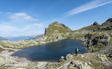 Hiker by a mountain lake