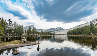 Hiker is standing on a lake