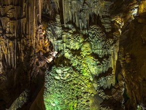 Stalactites in the colorfully lit cave Cuevas de Nerja
