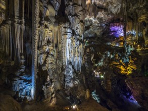 Stalactites in the colorfully lit cave Cuevas de Nerja