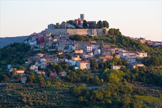Idyllic village on hilltop with Venetian fortress in morning light