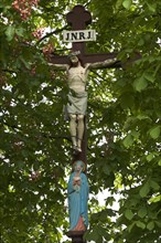Crucifix with Virgin Mary amongst chestnut leaves