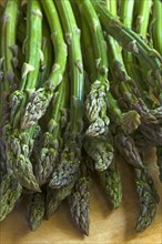 Fresh green asparagus on a wooden board