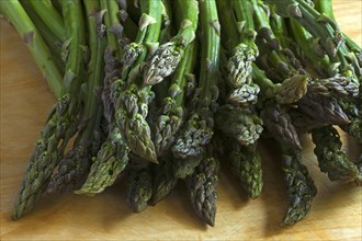 Fresh green asparagus on a wooden board