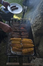 Grill with sausages and corn on the cob