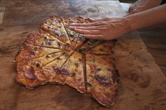 Stonebaked pizza being cut on a board