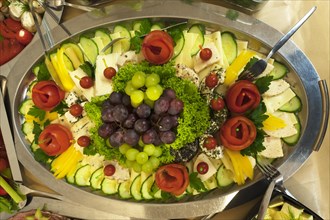 Cheese plate decorated with grapes