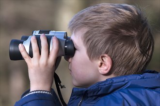 Boy looking through binoculars