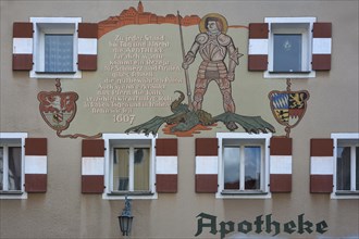 Mural with inscription and the St. George and the Dragon on the town pharmacy