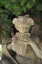 Statue of the shepherd god Pan in the courtyard garden