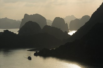 Boat on the water at sunset in the Ha Long Bay or Vinh Ha Long