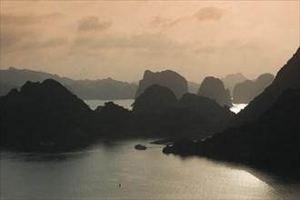 Boat on the water at sunset in the Ha Long Bay or Vinh Ha Long