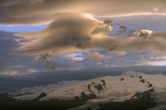 Midnight sunlit clouds above Hvannadalshnukur with glacier Oraefajokull