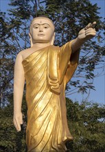 Buddha statue with extended arm and pointing finger