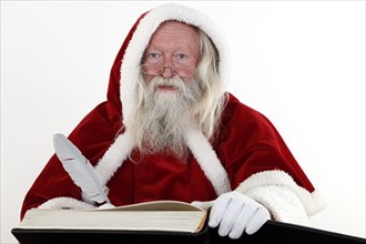 Santa Claus writes in a book