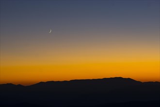 Sunset and crescent moon over the Sibillini Mountains