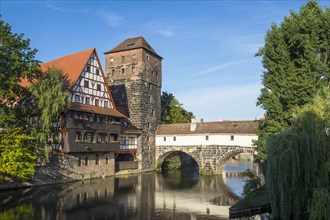 Old half-timbered house and water tower by the river Pegnitz