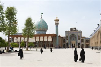 Women in chadors on the square in front of Shah Cheragh or Shah Cheragh mausoleum and mosque