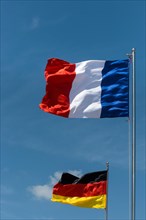 German and French flag blowing in the wind